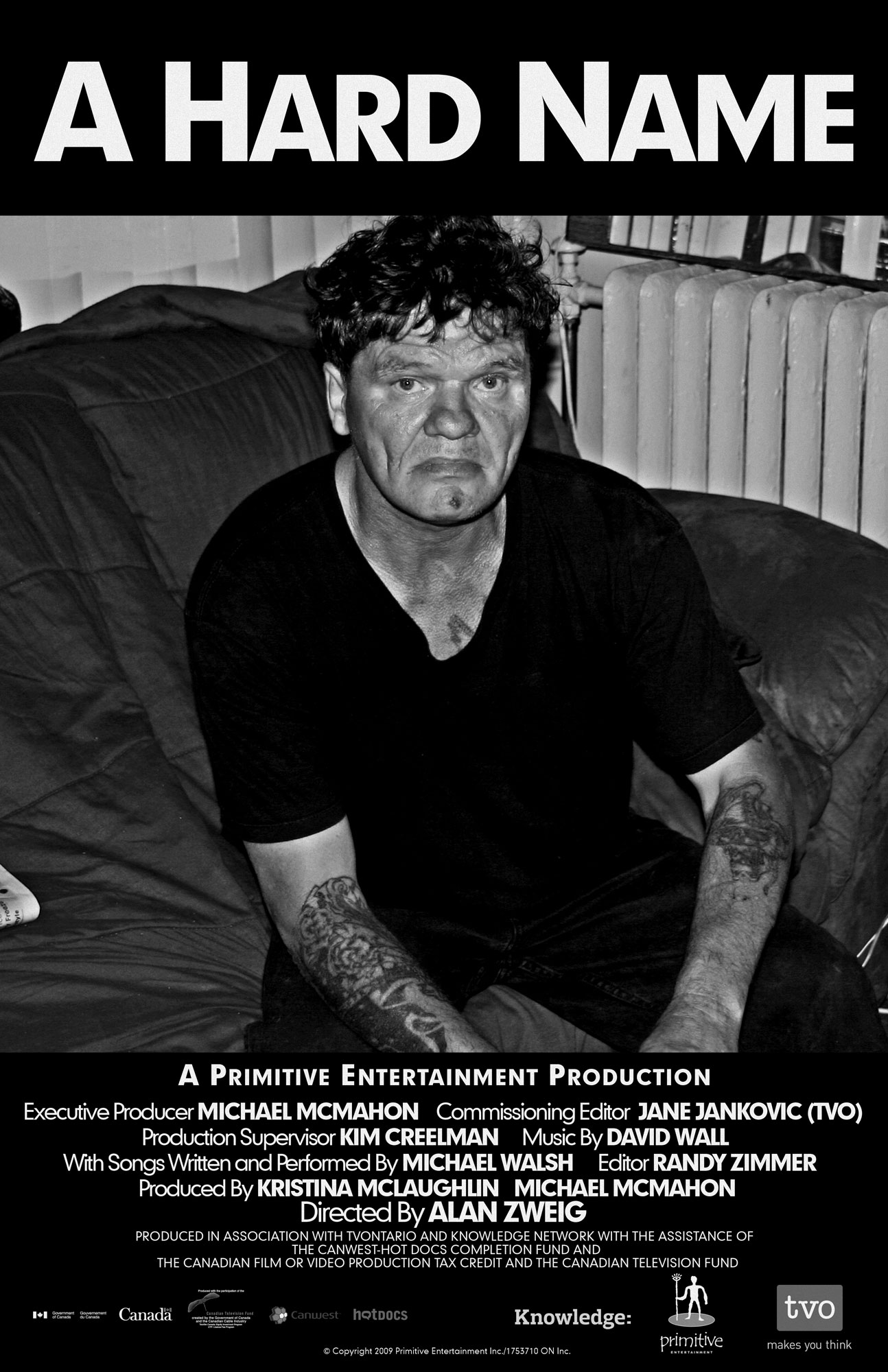 Official poster for A Hard Name: a black-and-white portrait of a tattooed man sitting on a couch, staring directly at the camera.