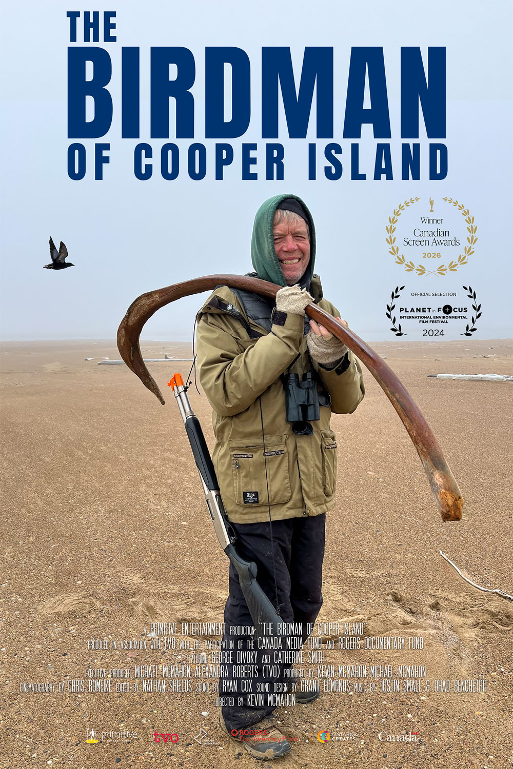 Official poster for The Birdman of Cooper Island: George Divoky stands on a barren Arctic beach holding a large piece of driftwood over his shoulder, a bird flying past in the background.