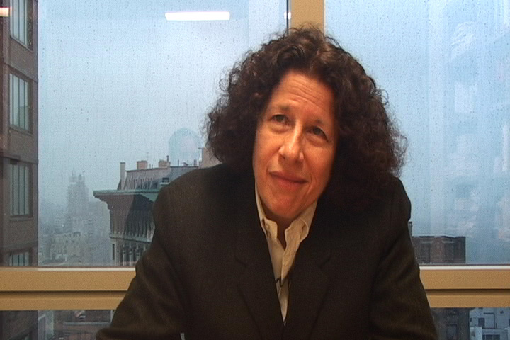 One of the film's subjects sits before a rain-streaked office window overlooking a city skyline.