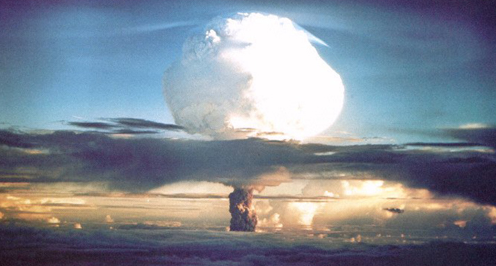 A mushroom cloud rises from a historical nuclear weapons test.
